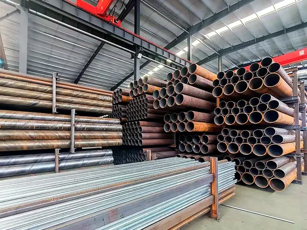Mixed steel sections and pipes stored in the workshop
